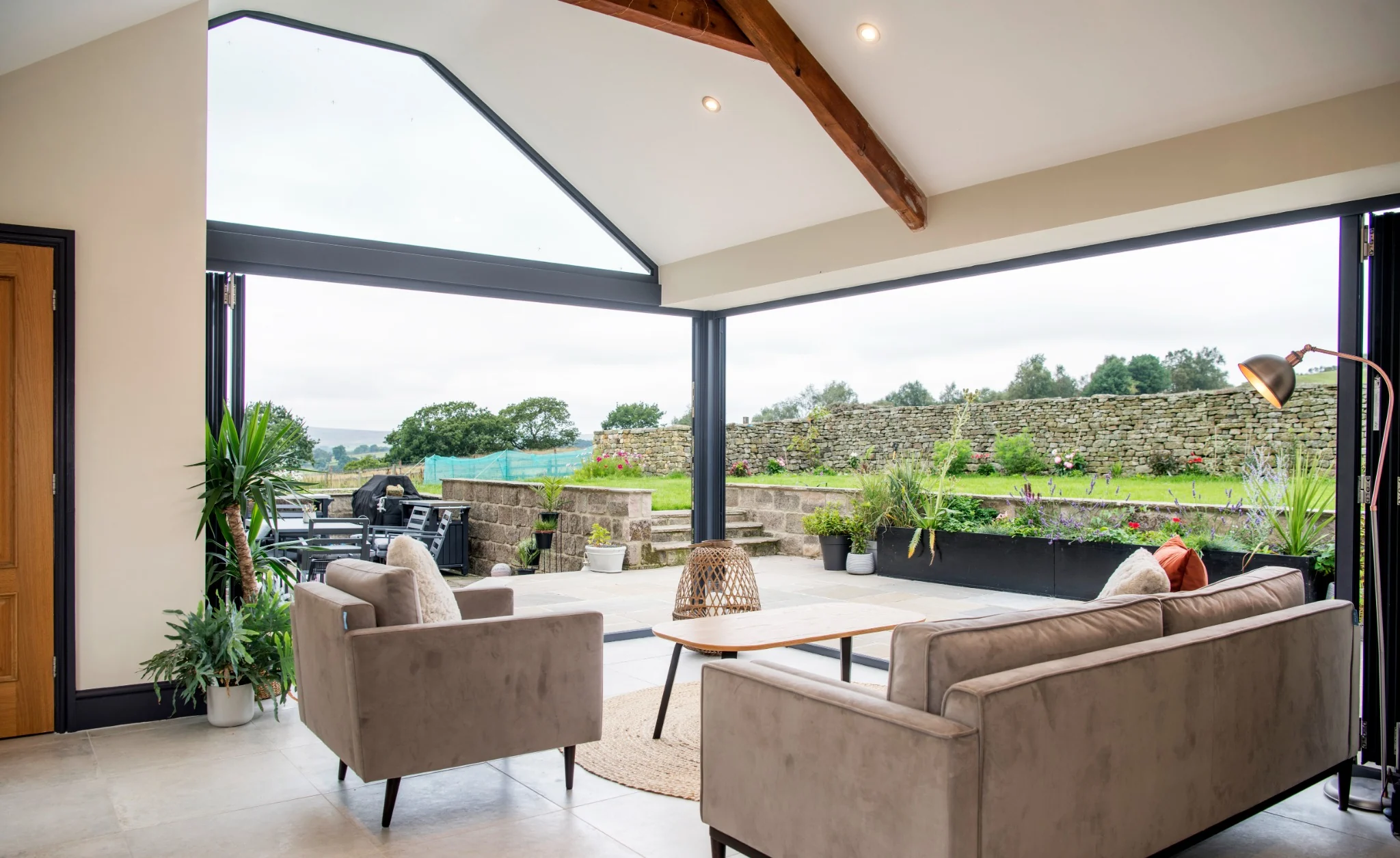 Farmhouse interior with contemporary glazing connecting to the garden